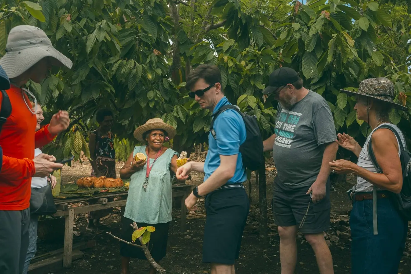 Grace Fekau giving visitors fresh cocoa beans to try from the Amazing Grace Cocoa trees.