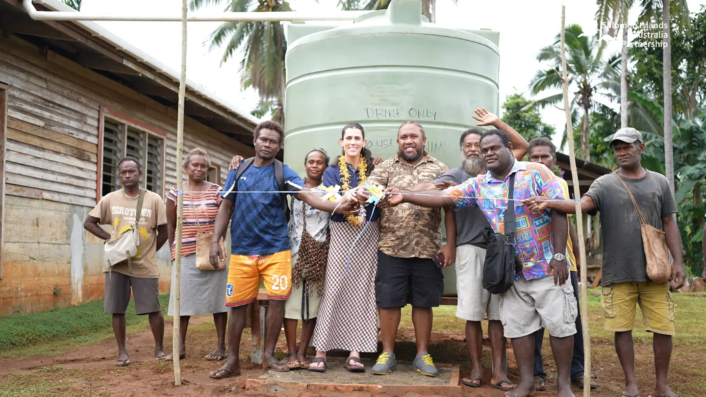 Australian High Commission Second Secretary Bridgette Cottrill, West Kwaio Constituency Development Officer and Assistant Project Coordinator Bobby Siarani, and members of the Sinamauri community open the new project.