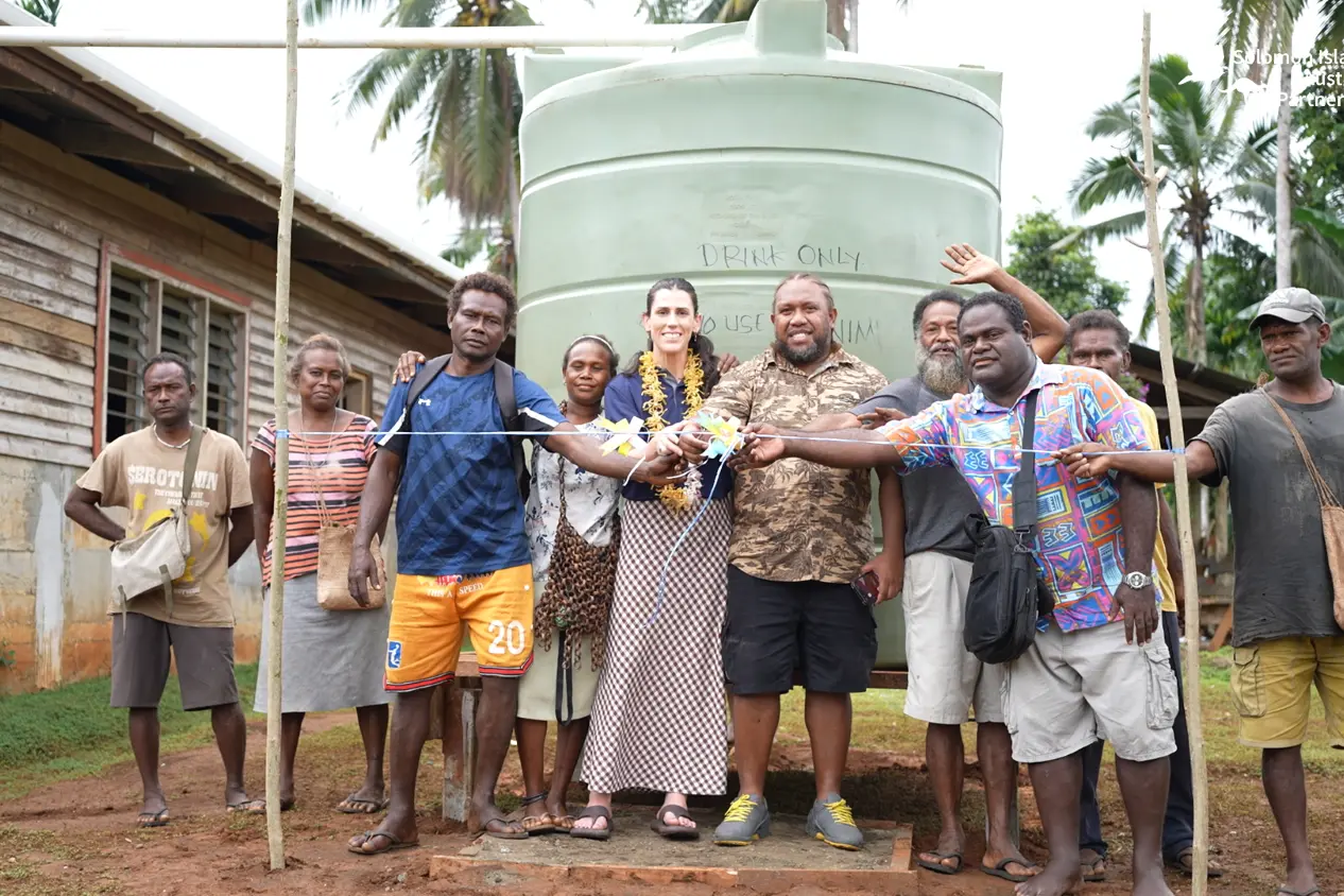 Australian High Commission Second Secretary Bridgette Cottrill, West Kwaio Constituency Development Officer and Assistant Project Coordinator Bobby Siarani, and members of the Sinamauri community open the new project.