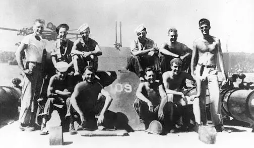 JFK and the PT-109. Lt. (jg) John F. Kennedy, USNR (standing at right) with crew of PT-109, Solomon Islands, 1943.