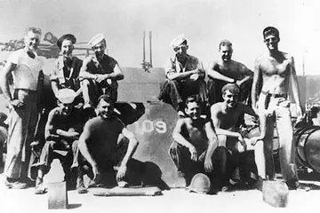JFK and the PT-109. Lt. (jg) John F. Kennedy, USNR (standing at right) with crew of PT-109, Solomon Islands, 1943.
