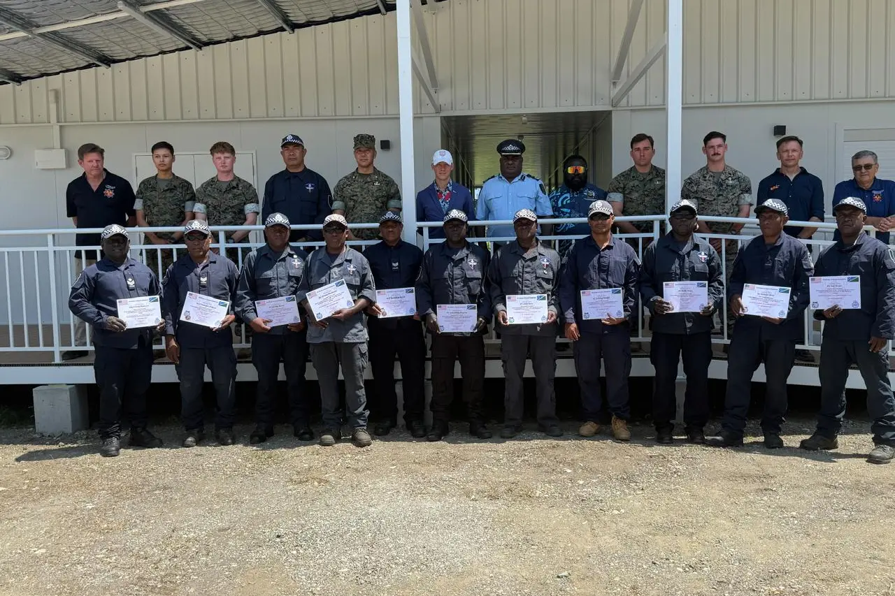 Royal Solomon Islands Police Force officers with certificates alongside U.S. Marines and officials at the new EOD facility at Hell's Point.