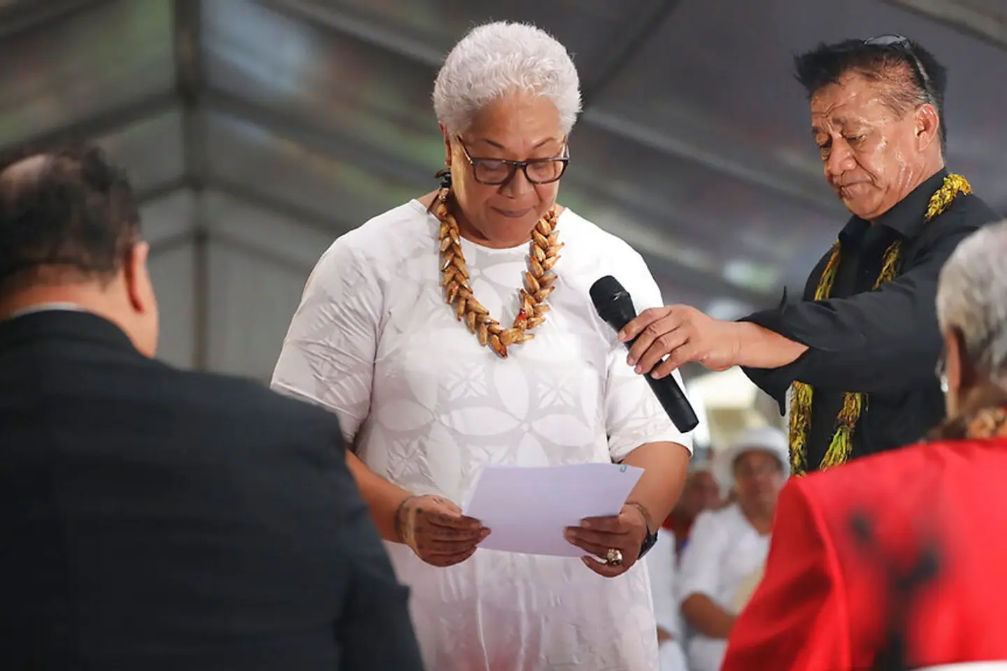 Samoa's first female prime minister was locked out of parliament by the country's outgoing leader - but still sworn into office in a makeshift ceremony held inside a tent.