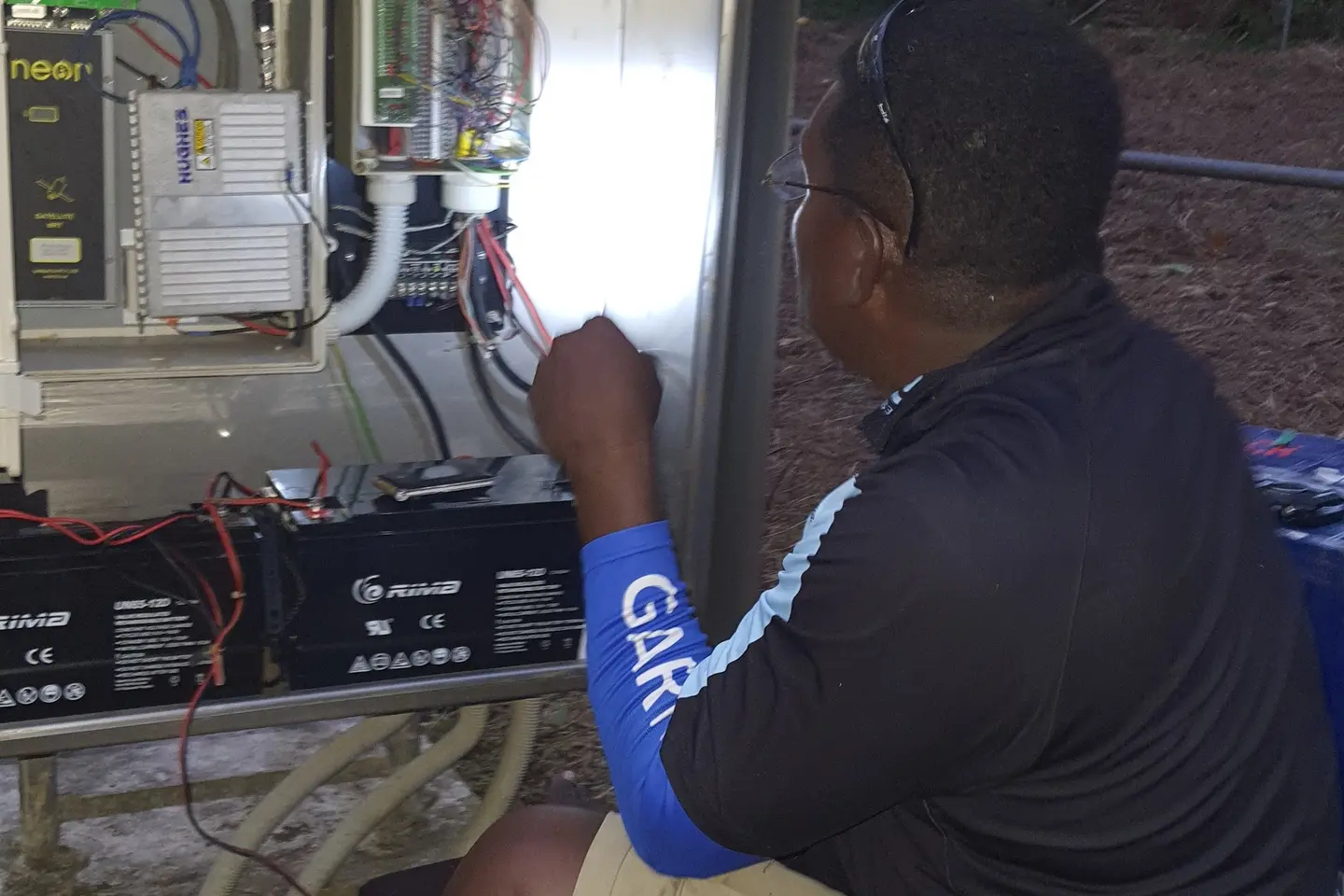 MET Service Chief Technical  Officer, Mr. Barnabas Tahunipue at work on the Automatic Weather Station in Tikopia