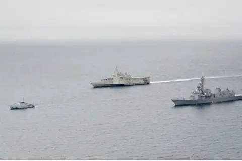 (From L) Solomon Islands Police Maritime patrol boat Taro, the U.S. Navy's littoral combat ship Oakland and Japan's Maritime Self-Defense Force destroyer Kirisame engage in a joint drill on Aug. 8, 2022, in the South Pacific.