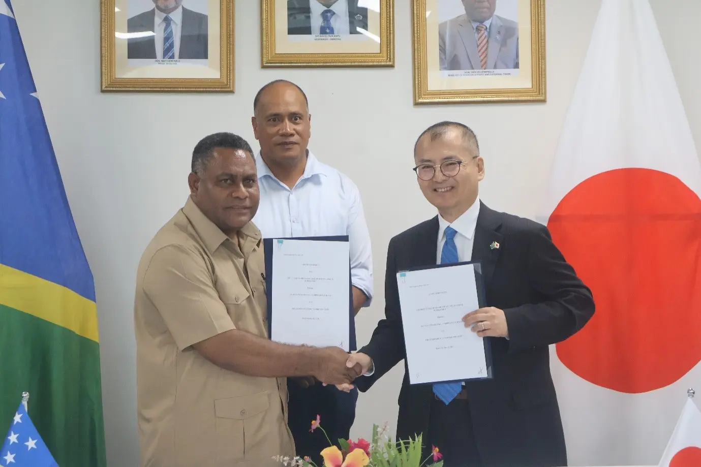 Hon Rexon Ramofafia and Mr Mitsuyoshi Kawasaki after signing the JDS grant agreement, with Hon John Tuhaika Jnr.