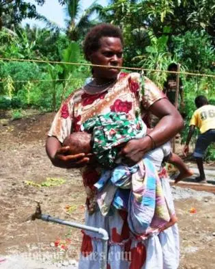 A woman with her child enjoying a necessity many take for granted, running water.