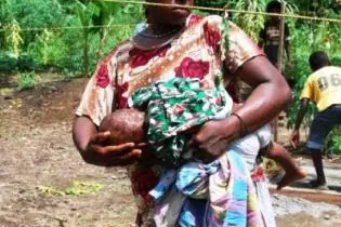 A woman with her child enjoying a necessity many take for granted, running water.