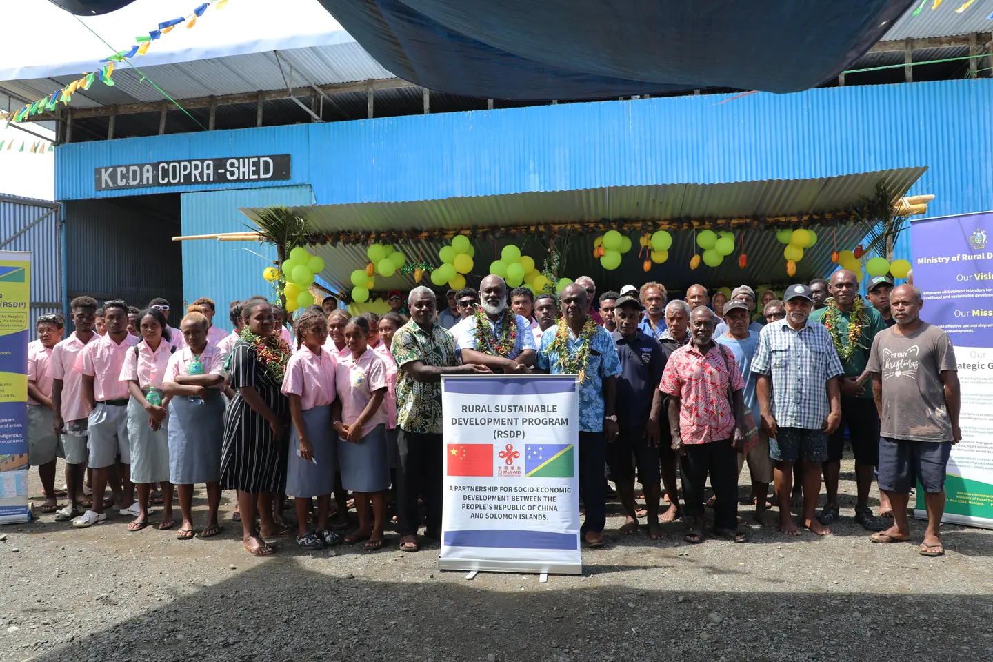 MRD Permanent Secretary John Misite'e (centre) shakes hands with Hon. Jeremiah Manele and KCDA Chairman Dudley Longamei as he officially hands over the facility, in the presence of farmers, chiefs, community leaders and school students at Kaevanga, Isabel Province.