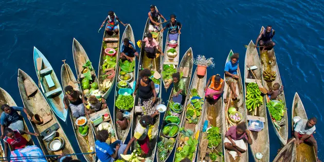 A boat market visits a cruise ship in the Solomon Islands.