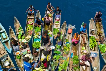 A boat market visits a cruise ship in the Solomon Islands.