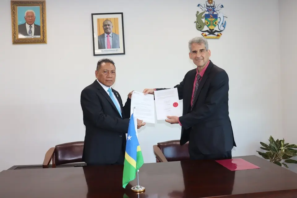 WHO Country Representative to SI Dr. Howard Sobel (R) presenting his credential to MFAET Supervising Minister Hon. Peter Shannel Agovaka (L)