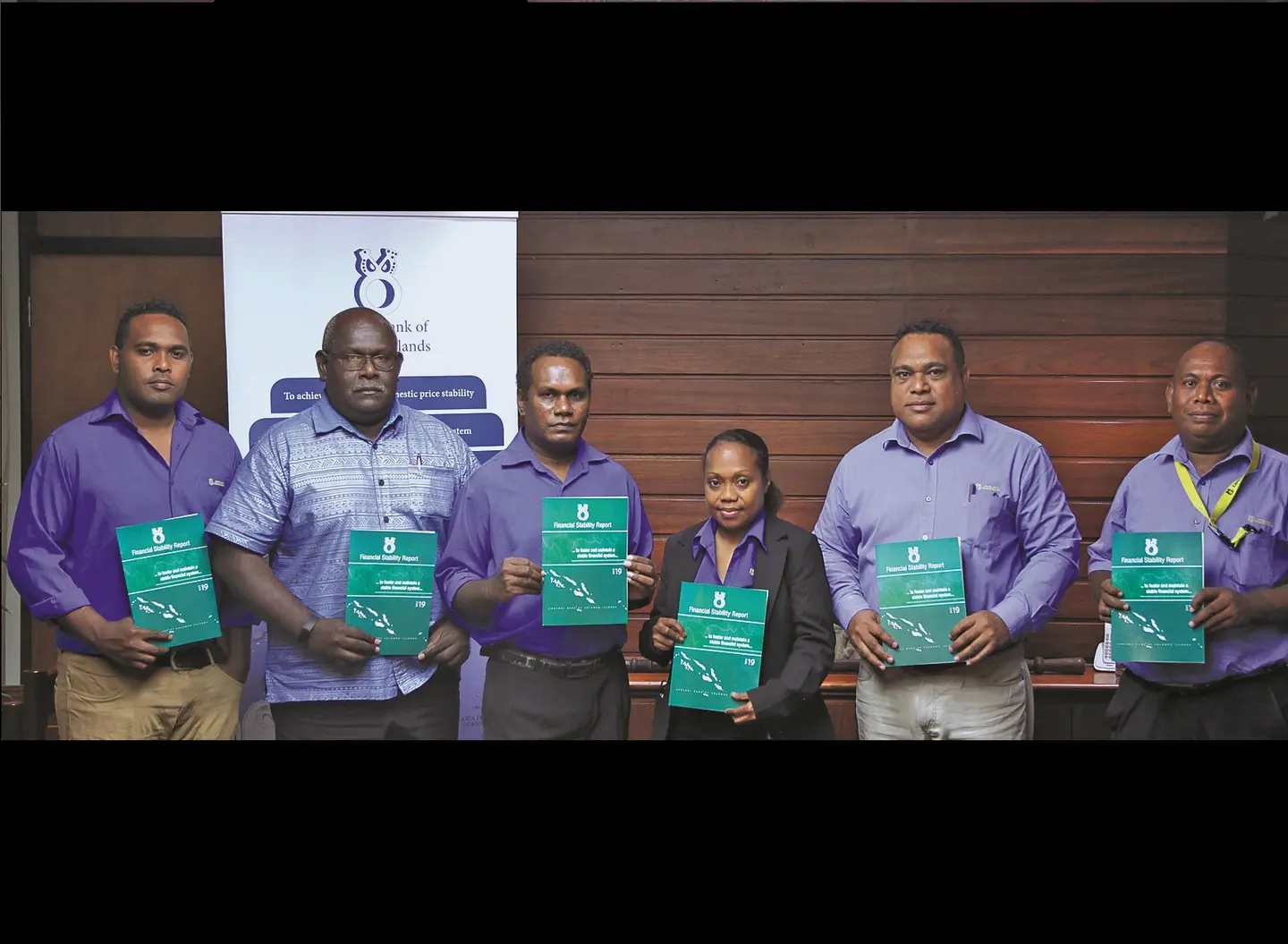 The Financial System Regulation Department (FSRD) Staff with Governor Dr. Luke Forau and Deputy Governor Raynold Moveni with the FS Report released on 02.07.2020.