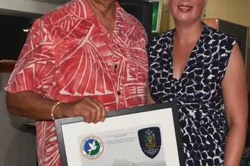 Secretary General of the Pacific Islands Forum, Tuiloma Neroni Slade receives a farewell gift from RAMSI Special Coordinator, Ms Justine Braithwaite during a RAMSI hosted function in Honiara.