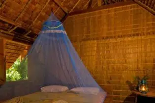 A room in a traditional leaf house at the TDA-run Tetepare Island Ecolodge.