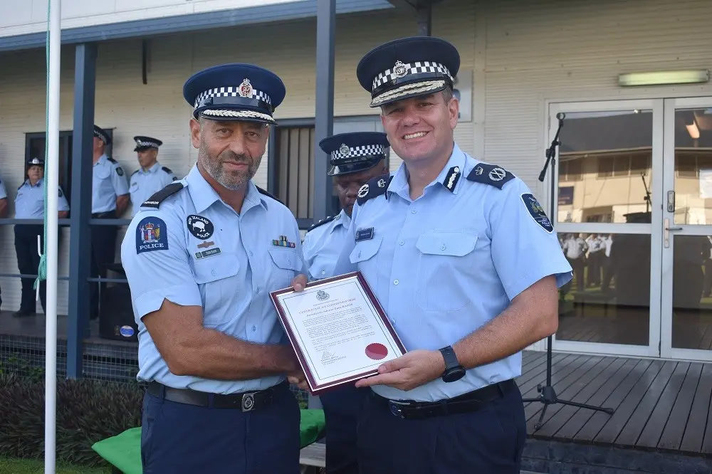 RSIPF Commissioner Varley presents outgoing SIPSP Team Leader Razos with a letter of commendation.