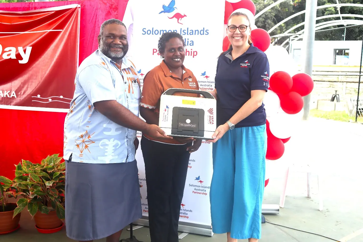 Ms Erin Ferguson, Senior Program Manager for the Health Team at DFAT, hands over the echocardiography machine to Deputy Secretary Health Improvement Dr Nemia Bainivalu and a representative of people living with rheumatic heart disease.