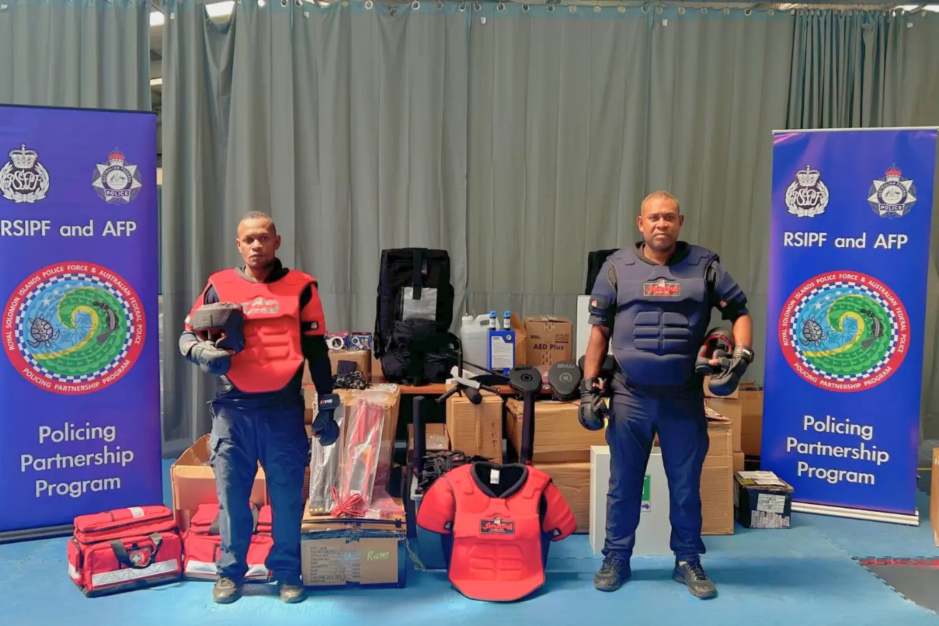 Two RSIPF OST officers demonstrate the newly donated operational safety training equipment.