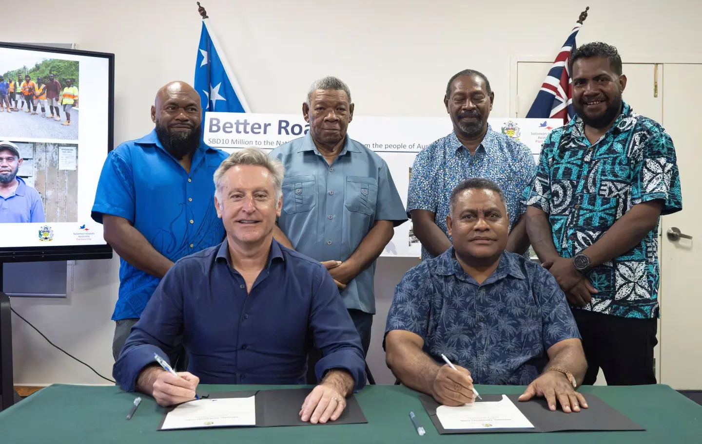 Australian High Commissioner Jeff Roach and Finance Minister Hon Rexon Ramofafia formalise Australia's additional SBD$10 million contribution to the National Transport Fund.
