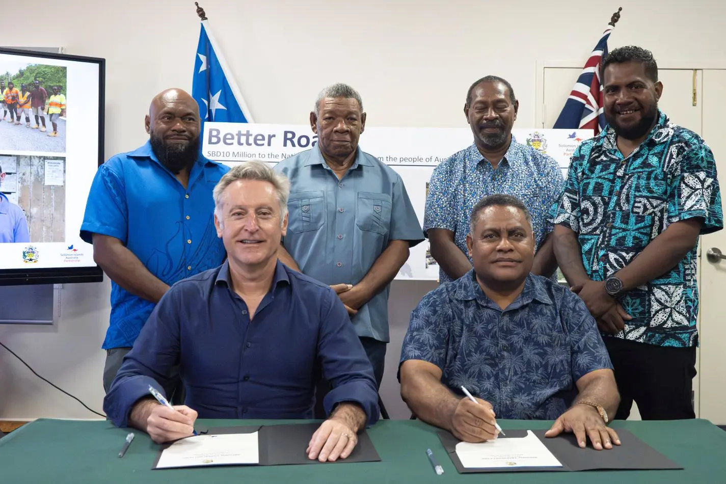 Australian High Commissioner Jeff Roach and Finance Minister Hon Rexon Ramofafia formalise Australia's additional SBD$10 million contribution to the National Transport Fund.