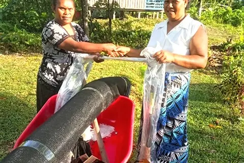 MAL Extension officer in Renbel, Florence Kwai hands over kava project farming tools to the representative of Renkav new kava planting family project.