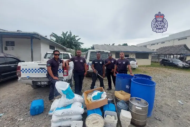 Police with the confiscated kwaso items used for the production of the illegal homebrew.
