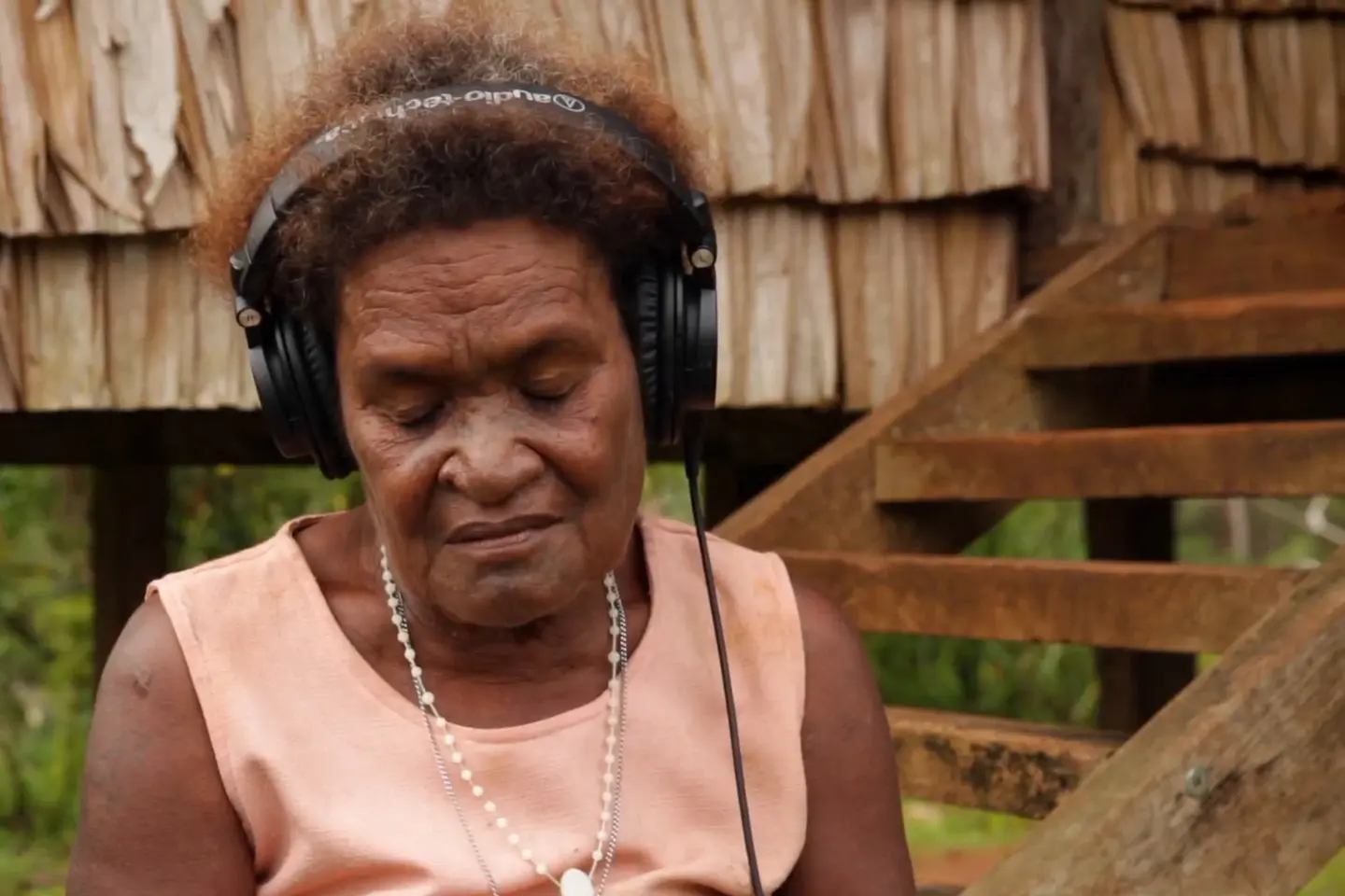 Helen, Afunakwa's last surviving child, listens to the 1969 recording of her mother's voice in the opening scene of Searching for Afunakwa.