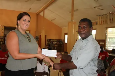 Second Secretary & Consul, Australian High Commission, Natasha Whelan, presents Mr. Jiope, school principal, with a grant for the Livelihood project.