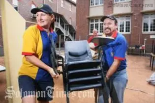 Rotary Club of Booval president Cheryl-Anne DeLima and past president Russell Bentley loading furnitures to be donated to Auki Primary.