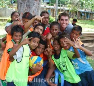 Australian High Commission Third Secretary, William Ewing, with young volleyball players in Gizo, Western Province.