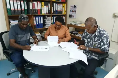 Mr Tony Tepeaihana, Managing Director of Food Works Supplies Ltd, MAL Permanent Secretary Mrs Ethel Tebengi Frances and MAL Undersecretary Technical Michael Ho’ota signing the funding agreement.