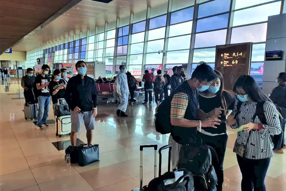 The group of 68 Malaysians upon their arrival at the Kuching International Airport before they were taken to the quarantine centres, March 16, 2021.