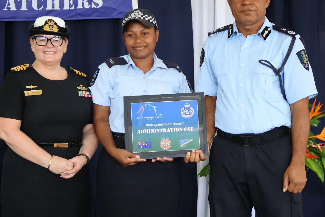 PC Bethy Panai Nai receives the High Achieving Student award for the inaugural Administration Course from Acting Commissioner RSIPF James Aitorea and Australian Defence Advisor Captain Emma Griffiths.