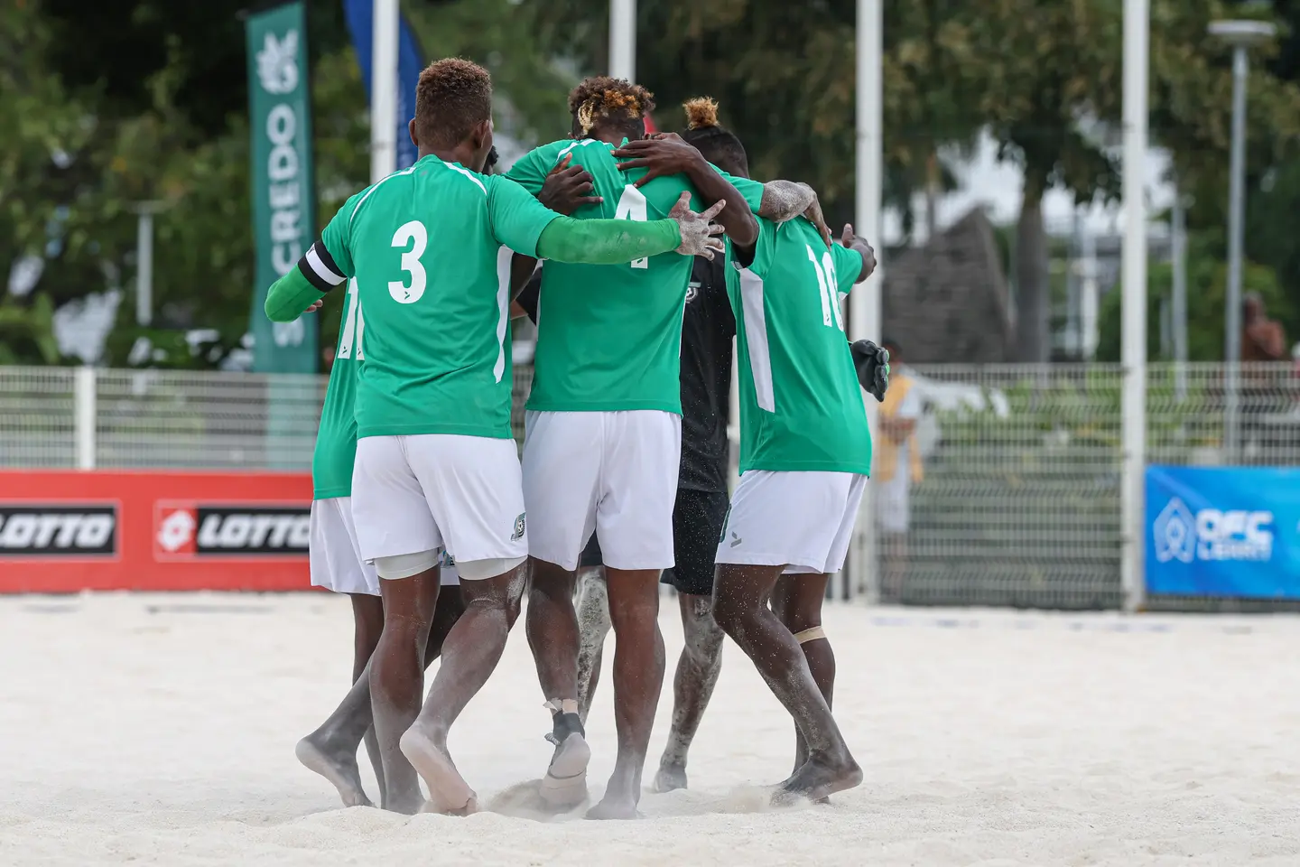 Players in green celebrate a goal at the OFC Beach Soccer Men's Nations Cup 2026 in Tahiti.