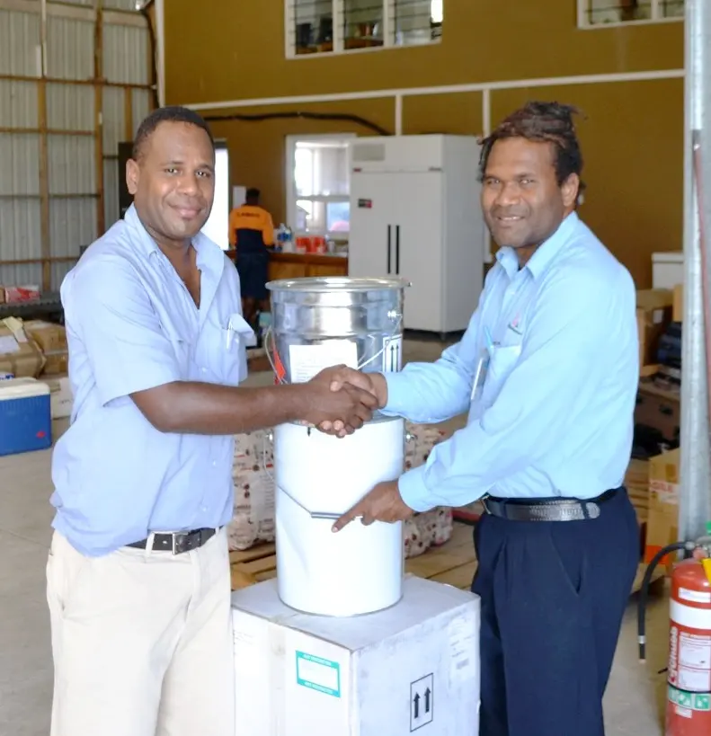 The buckets of paint were handed over to the President of the Rotary Club Sebastian Ilala (left).