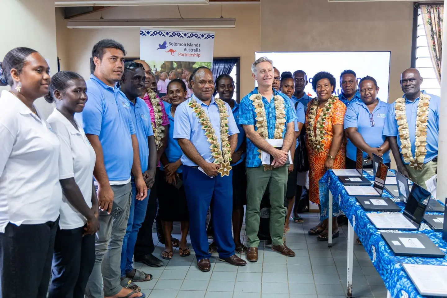 Guests and SINU students in the Kukum Campus Library during the handover of computers and learning resources.
