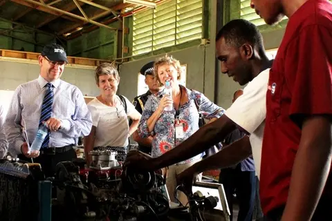 A mechanics student provides a demonstration to AusAID Director General Peter Baxter.