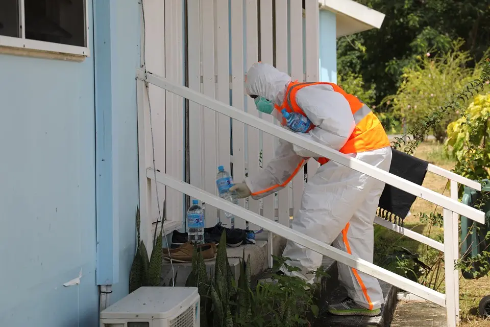 A front-line officer supplying water to one of the rooms at the GBR quarantine centre.