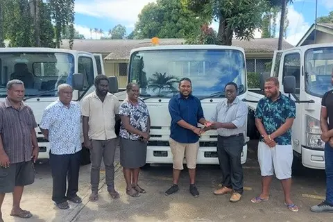 Health PS, Mrs. McNeil next to Central Islands Provincial Health Director Dr Leslie Bunabo who received key to one of the 3 tonne trucks from MHMS Deputy Secretary Dr Gregory Jilini along-side World Bank and MHMS staff.