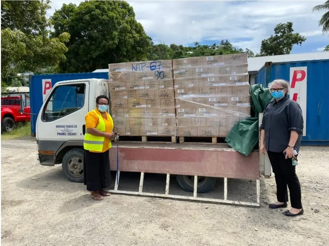 Permanent Secretary of Ministry of Agriculture and Livestock, Ethel Tebengi Frances and Acting Australian High Commissioner, Sally-Anne Vincent with food supplies for communities in Honiara.