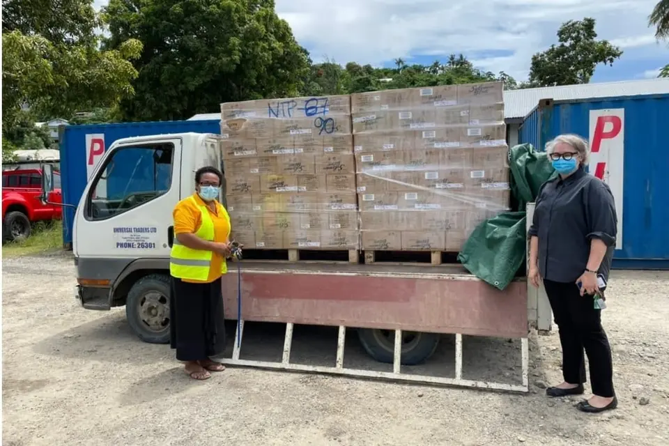 Permanent Secretary of Ministry of Agriculture and Livestock, Ethel Tebengi Frances and Acting Australian High Commissioner, Sally-Anne Vincent with food supplies for communities in Honiara.