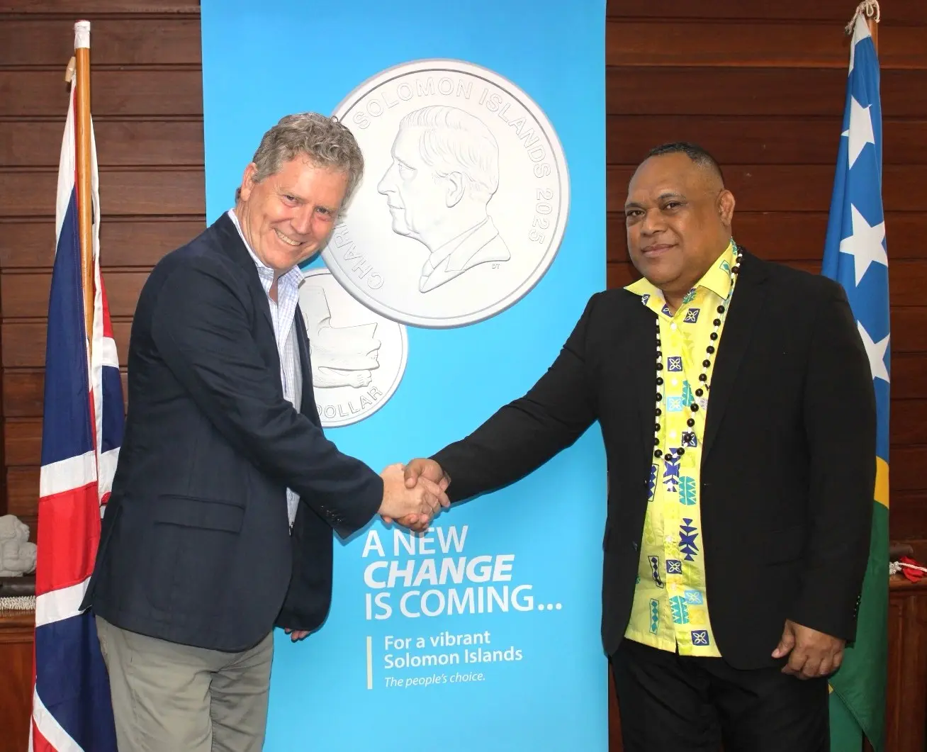 British High Commissioner Paul Turner and Governor of the Central Bank of Solomon Islands Dr Luke Forau shake hands to launch circulation of the 50 cent coin.