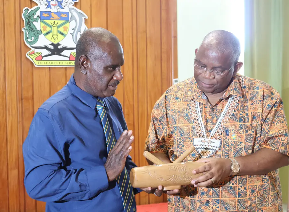 Minister of Foreign Affairs and External Trade, Hon. Jeremiah Manele presenting a gift to the Secretary General of the Secretariat of the Organization of African, Caribbean and Pacific States (OACPS), H.E Dr Georges Rebelo Pinto Chikoti.