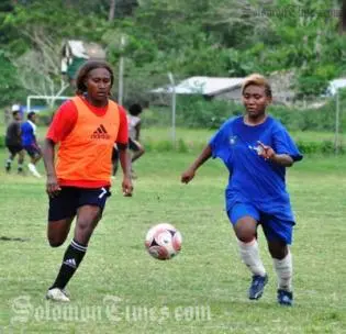 Rose Gwali (L) competes with Joy Timo of Honiara Select for the ball.