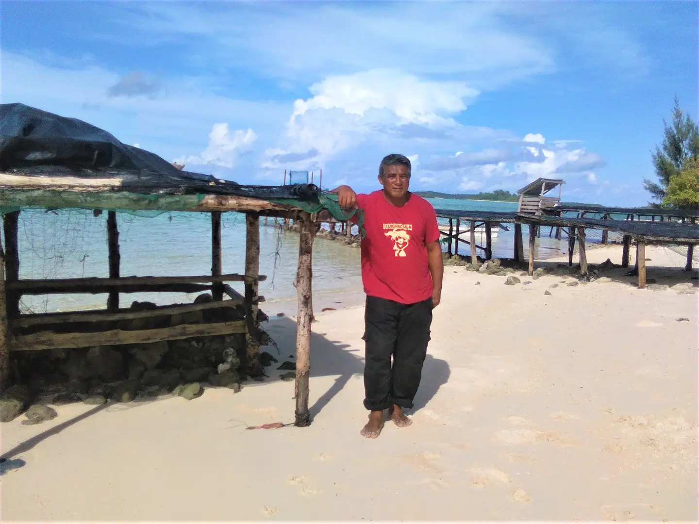 Mr Ata standing beside his table on the island of Peniamina, just outside of Wagina.