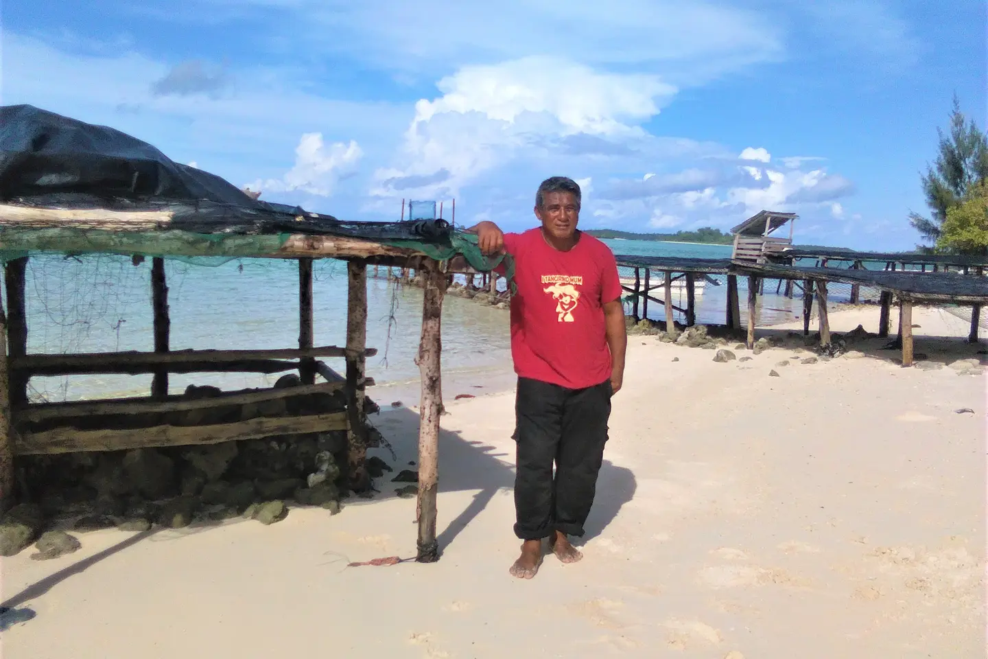 Mr Ata standing beside his table on the island of Peniamina, just outside of Wagina.