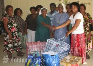 Madam Sikua (second right) hands over donation to the Centre.
