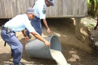 Police pouring out litres of home brewed Kwaso destined for the streets of Honiara.
