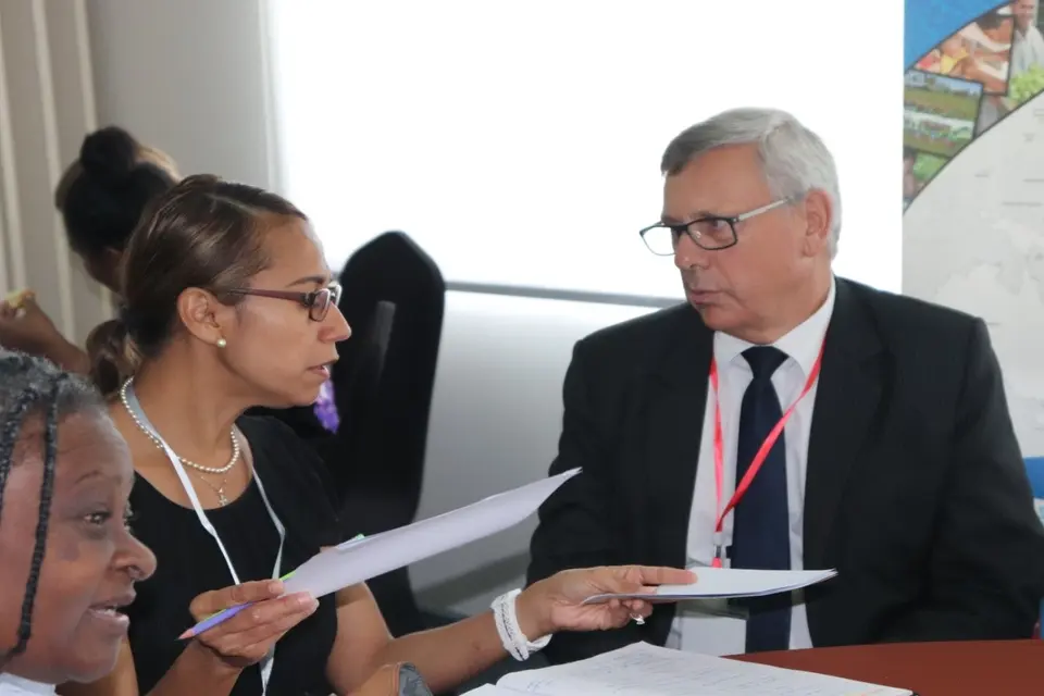 Mr. Howard Lawry, Public Solicitor (right) discusses with Andie Driu, Prosecution Advisor of Police Prosecutions Department RSIPF.